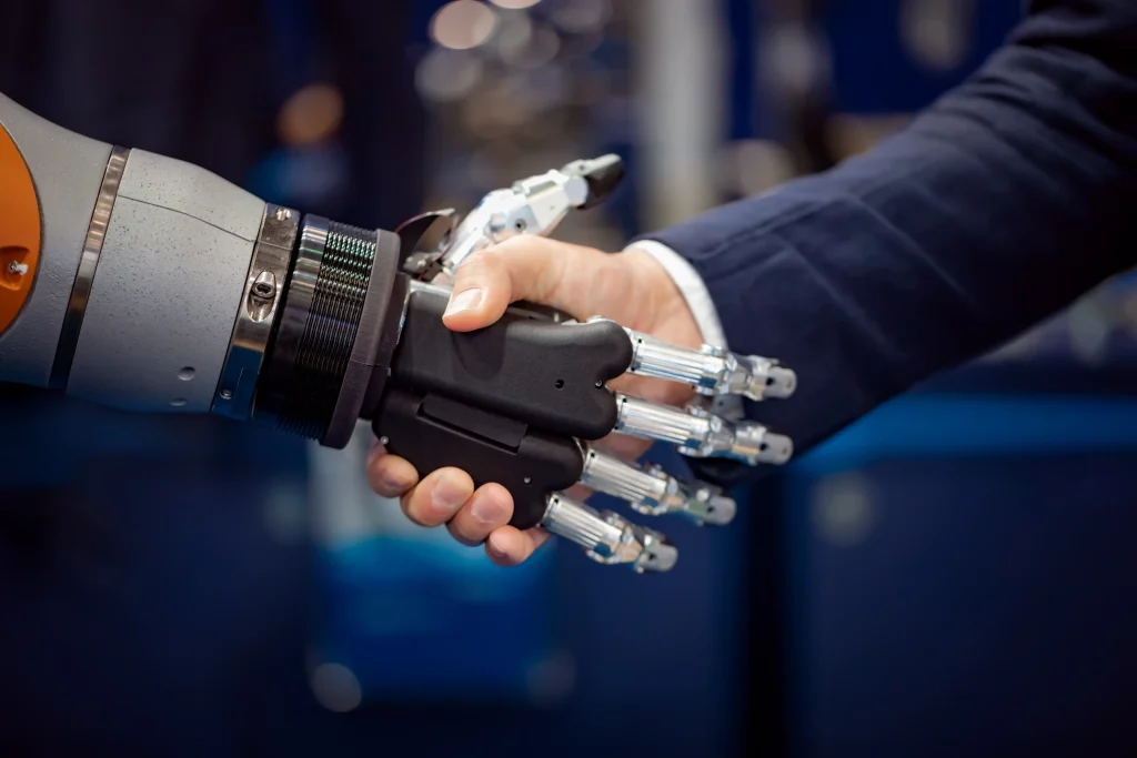 28 Remarkable Quotes About Artificial Intelligence to Make You Wonder 2 hand of a businessman shaking hands with a android 2022 02 02 03 49 01 utc
